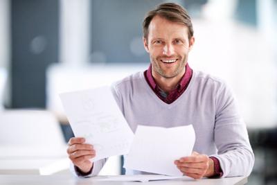 man happy and holding paperwork