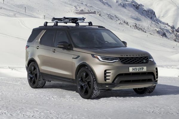 bronze land rover discovery parked on snow