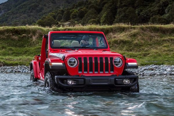 red jeep wrangler drive through water
